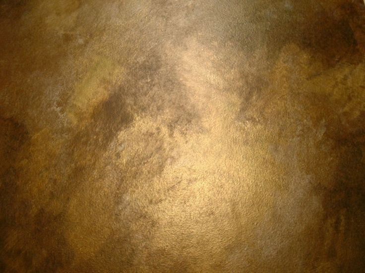 a close up view of the top of a table with brown and gold paint on it