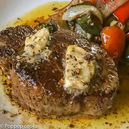 a close up of a plate of food with meat and vegetables