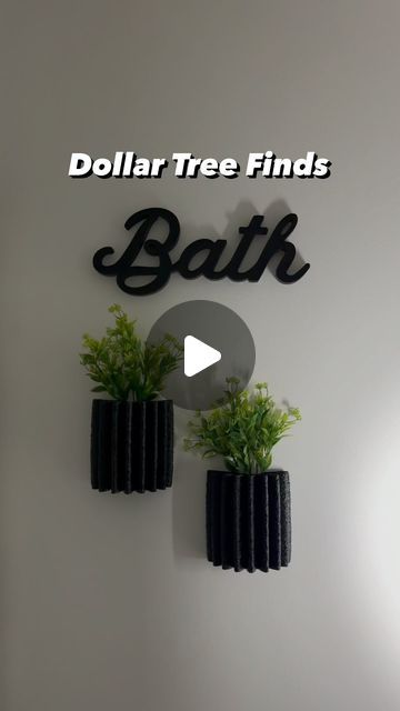 a sign that says dollar tree finds bath on the side of a wall with plants in it