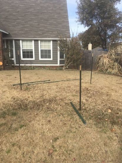 an empty yard in front of a house with no grass on the ground and trees