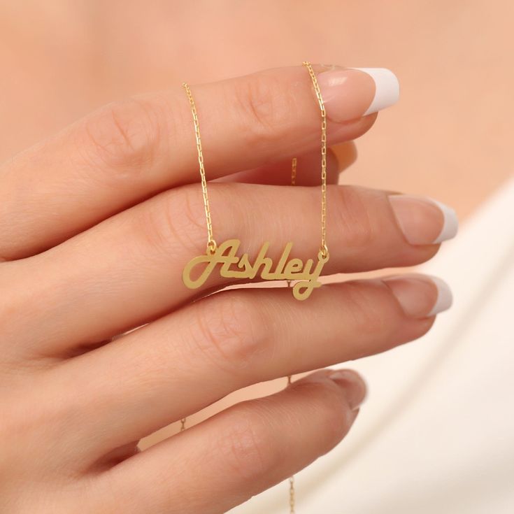 "Elevate your style with our 14K Solid Gold Personalized Name Necklace to leave a lasting impression. This specially named necklace is a beautiful piece of jewelry that you can add to your jewelry collection. A special gift that you can present to your loved ones and yourself. 🔸🔸 Our elegant, style and stylish products suitable for special occasions and daily use are produced with love and care for you and your loved ones. 🔸🔸 All of our products are carefully crafted from 14K Solid gold. FEA Customizable Yellow Gold Anniversary Necklace, Customizable 14k Gold Anniversary Necklaces, Signature 14k Gold Wedding Jewelry, Customizable Classic Yellow Gold Necklaces, Classic Customizable Yellow Gold Necklaces, Classic Customizable Yellow Gold Necklace, Yellow Gold Custom Nameplate Necklace For Anniversary, Classic Jewelry With Hallmarks For Mother's Day, Custom Yellow Gold Nameplate Necklace For Anniversary