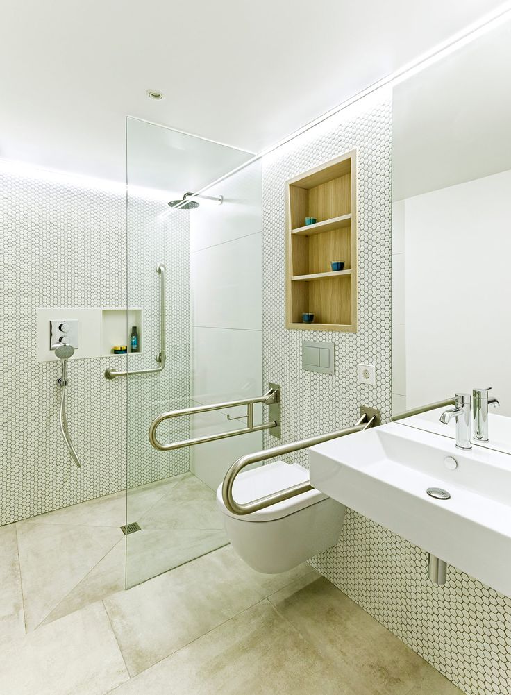 a bathroom with a toilet, sink and shower stall in the middle of it's walls