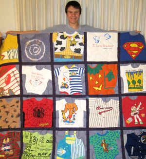 a man is holding up a quilt made with t - shirts