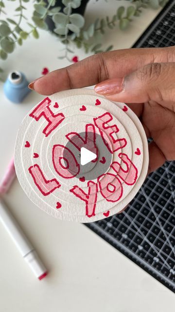 a person holding a paper plate with the words i love you on it