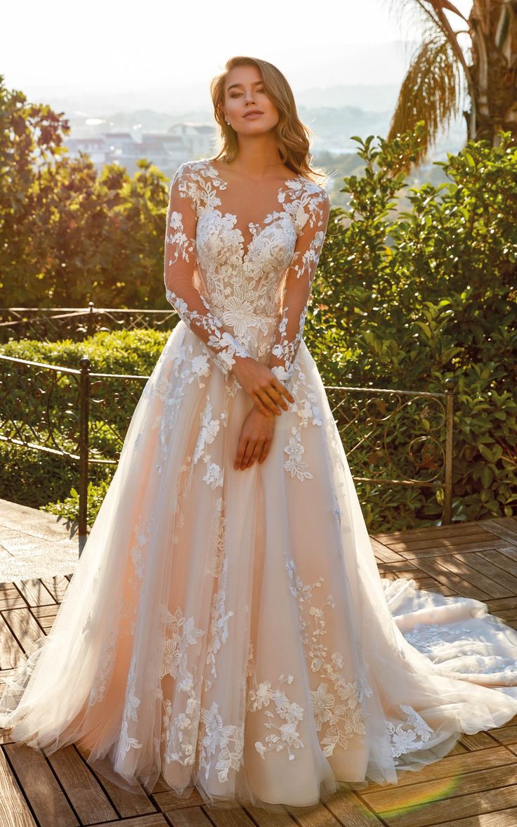 a woman in a wedding dress standing on a deck