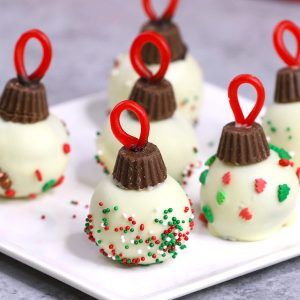 white chocolate covered desserts with red ribbons on a plate