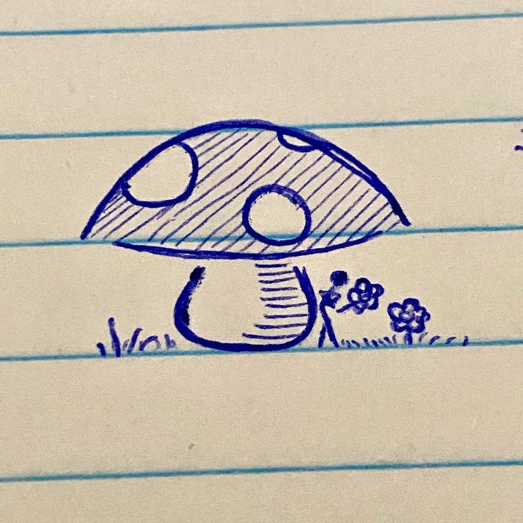 a drawing of a mushroom sitting on top of a piece of paper with writing underneath it