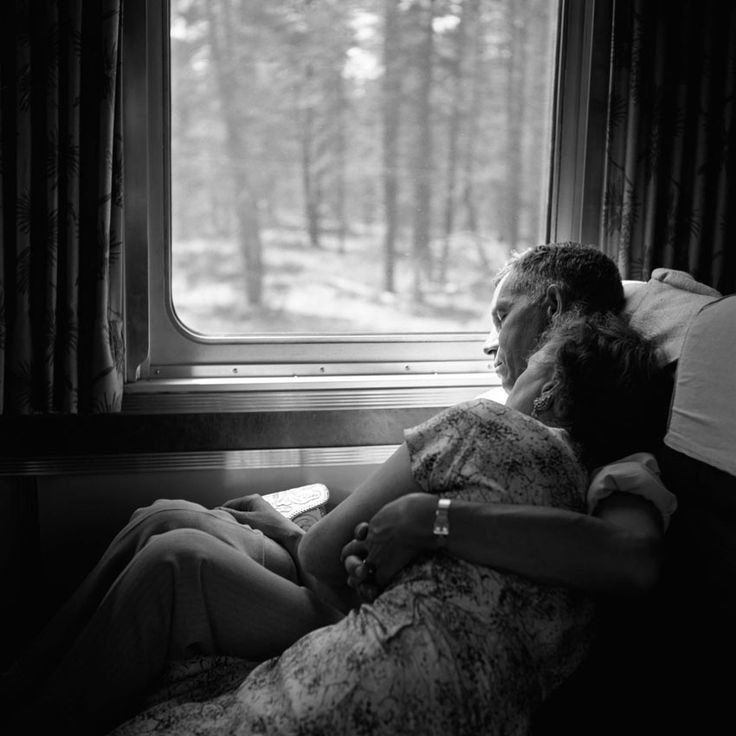 an image of two people sitting in front of a window with the words love on it