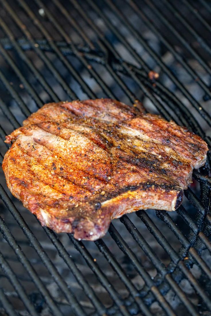 a steak is cooking on the grill with it's side being grilled off