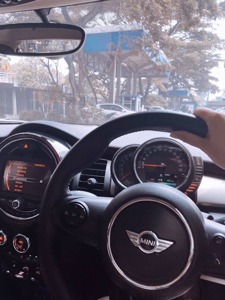 the interior of a car with steering wheel, dashboard and gauges on it's dash