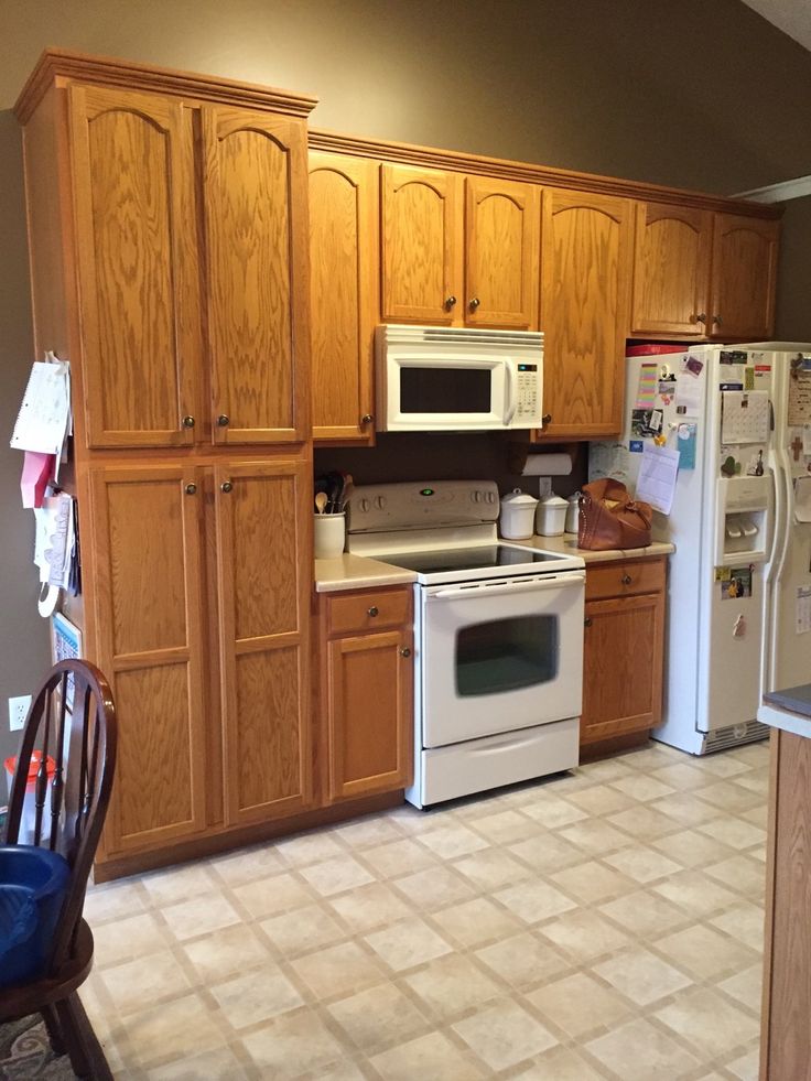 a kitchen with wooden cabinets and white appliances