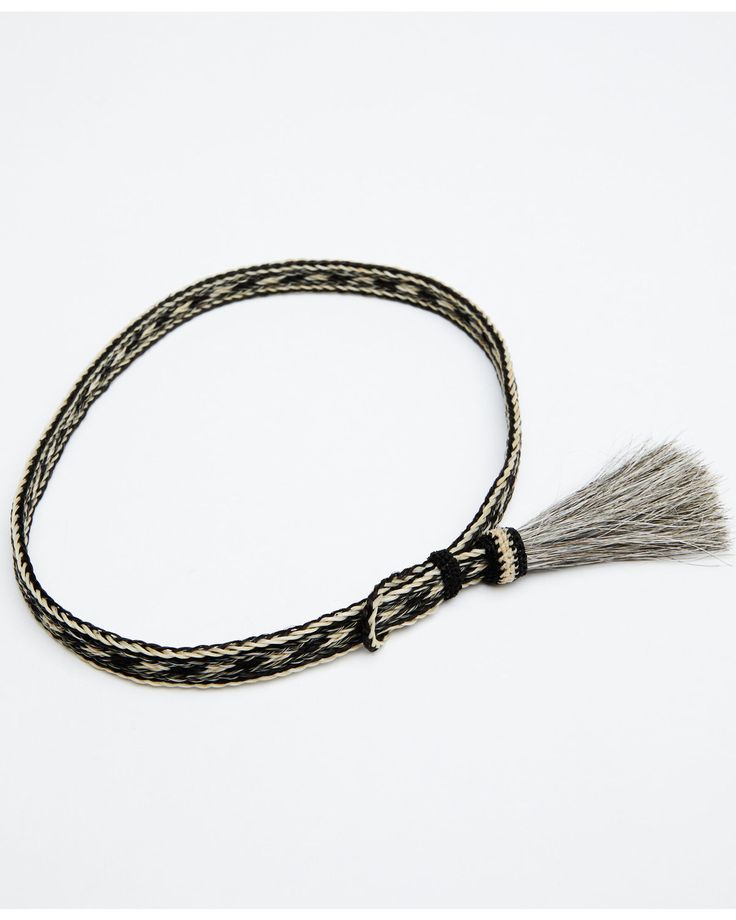 a black and white braided bracelet with a tassel hanging from it's end