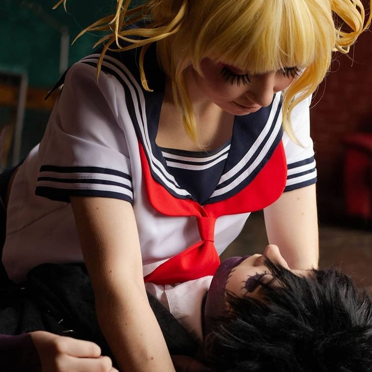 a woman with blonde hair is being assisted by a man in a red and white shirt