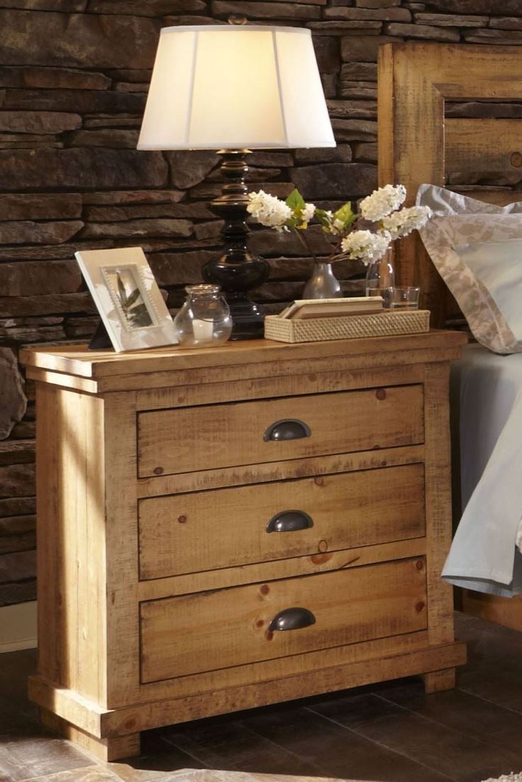 a wooden night stand with two drawers and a lamp