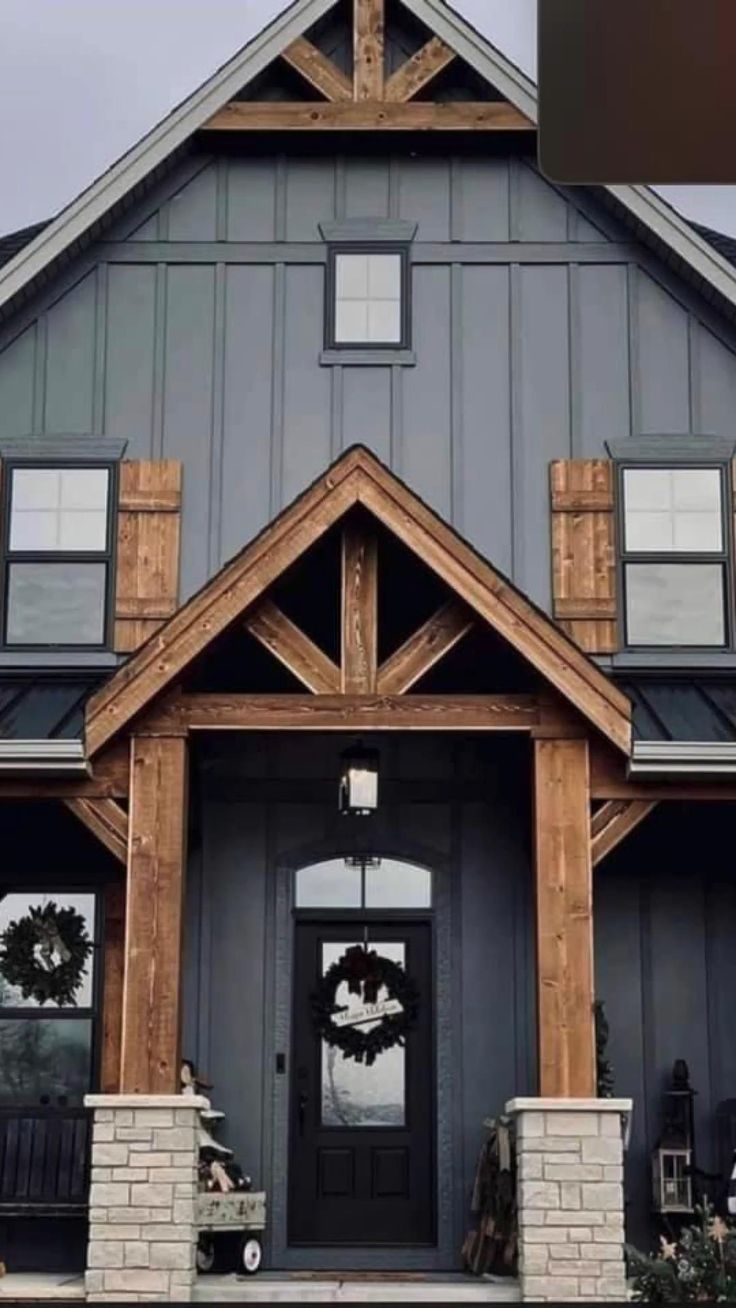 a large gray house with black doors and windows