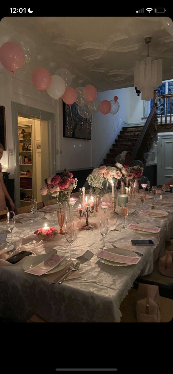 a long table is set with plates and candles