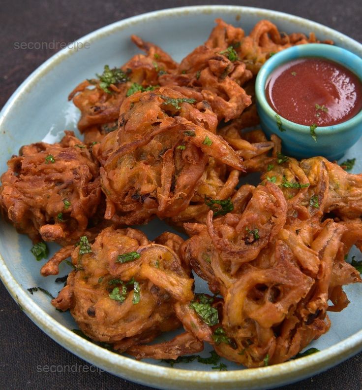 some fried food is on a plate with dipping sauce