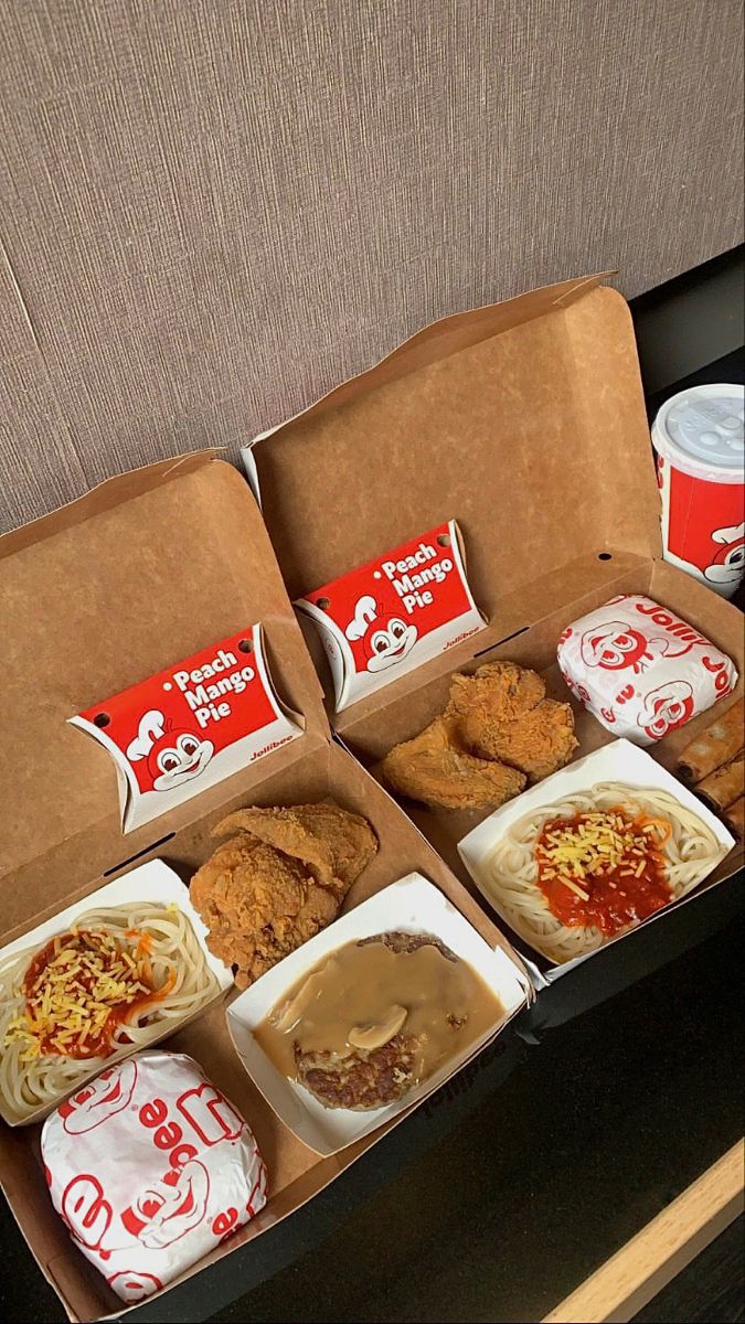 an open take out box filled with different types of food and condiments on a table