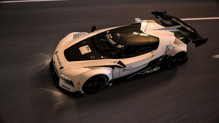 a white and black sports car driving down the road