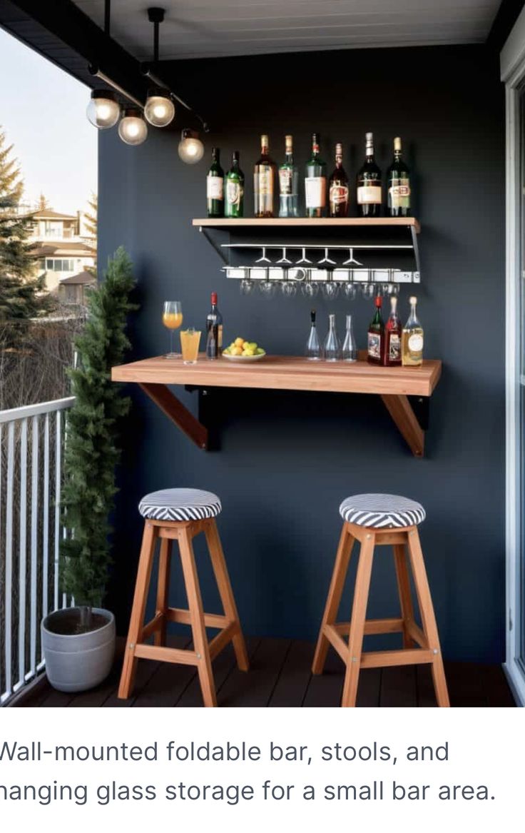 two wooden stools sitting next to a bar on top of a balcony with bottles and glasses