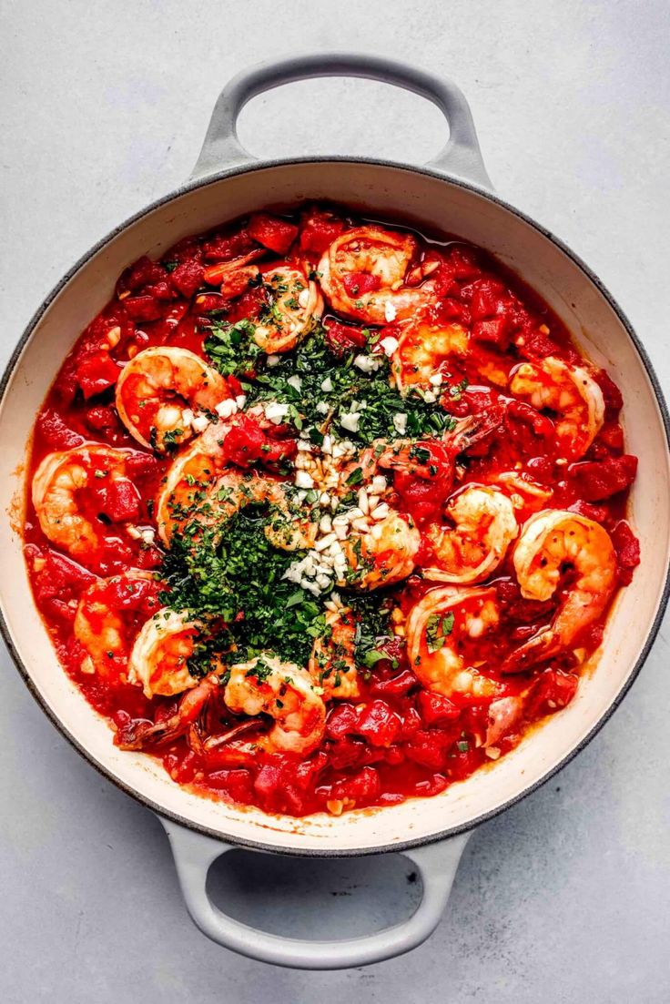 a pan filled with shrimp and tomato sauce