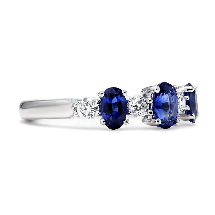 Our Oriana Ring features a slightly larger oval shaped sapphire set at the center with two graduating sizes set on each side. Between each of the sapphires are shimmering round diamonds whose colorless hues offer a clear contrast from the deep royal blue shades of each sapphire. This timeless creation will certainly make for a wonderful alternative engagement band. Metal: 18kt Gold Sapphire Weight: 1.30 ct. Diamond Weight: 0.28 ct. *Please note that the listed ct. weights are approximate and may Three Stone Lab-created Sapphire Ring For Formal Occasions, Formal Three Stone Sapphire Ring With Lab-created Sapphire, Formal Three Stone Lab-created Sapphire Ring, Formal Three-stone Lab-created Sapphire Ring, Formal Three-stone Sapphire Ring Fine Jewelry, Formal Three Stone Sapphire Ring, Formal Three-stone Sapphire Ring, Timeless Sapphire Ring In Diamond White, Timeless Oval Sapphire Ring With Prong Setting