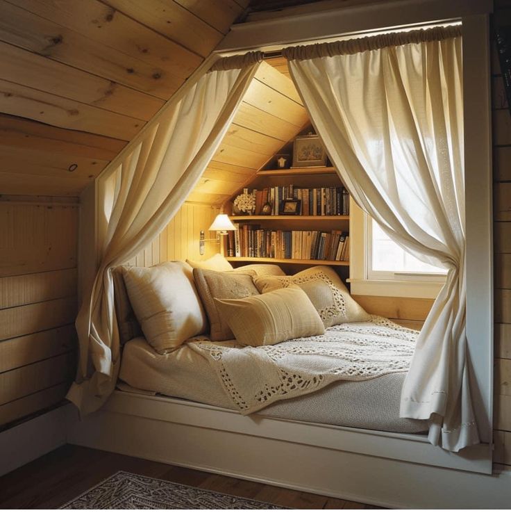 a bed with white sheets and pillows under a window