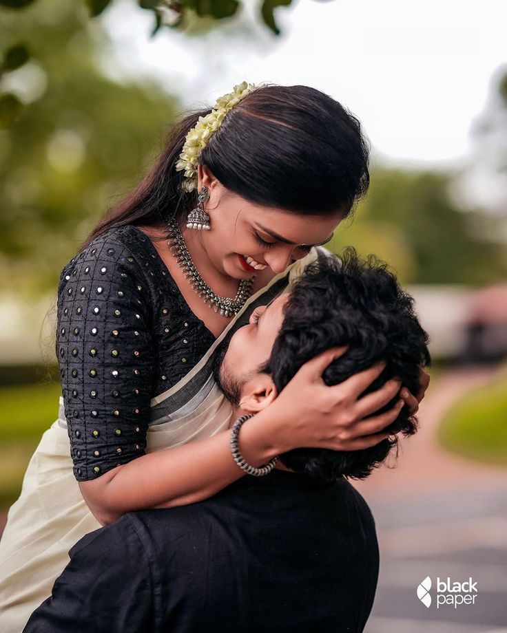 a woman is hugging a man in the street