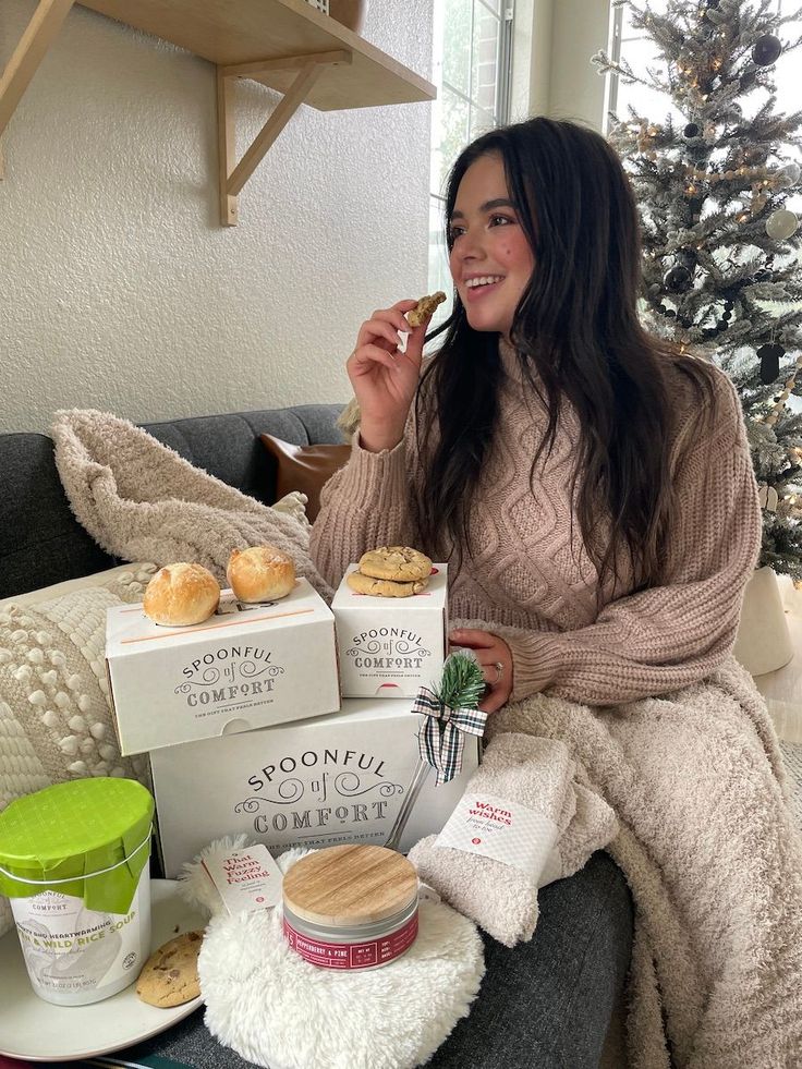 a woman sitting on a couch eating some food