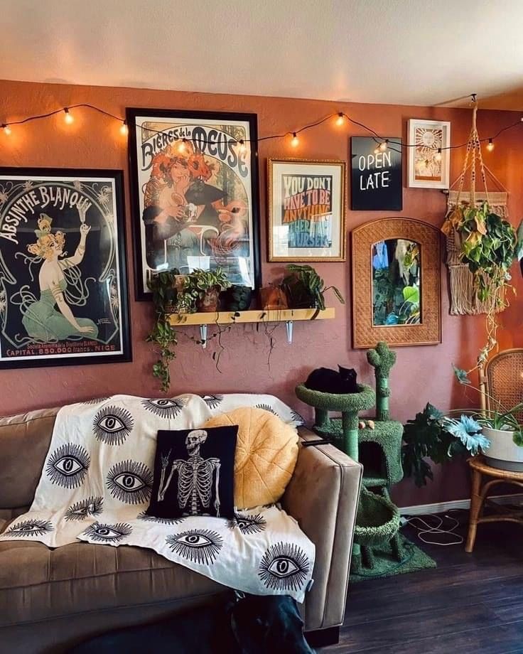 a living room filled with furniture and pictures on the wall