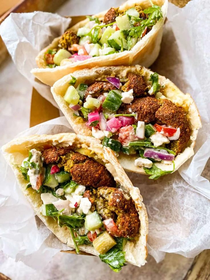 three pita breads filled with meat and vegetables