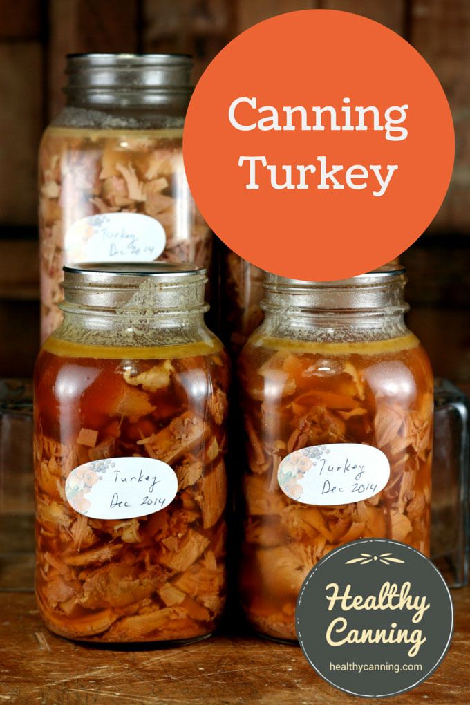 two jars filled with food sitting on top of a wooden table next to each other