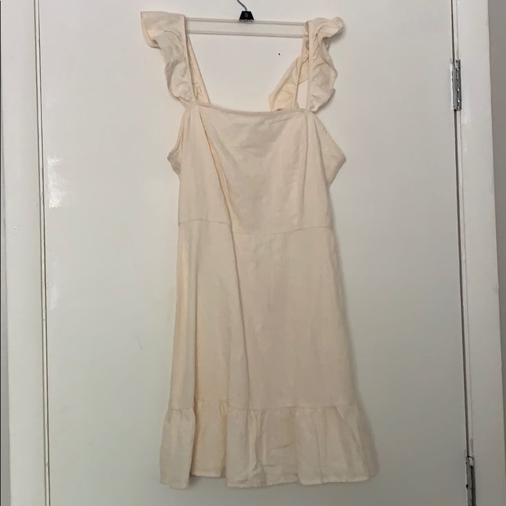 This Is A Super Cute Cream Linen Dress. It Has A Ruffle Style Sleeve And Bottom Detail. Zipper On The Back White Sundress With Ruffled Straps For Brunch, White Ruffle Dress With Ruffled Straps For Day Out, Chic White Sundress With Ruffle Hem, White Ruffle Dress With Ruffled Straps For Summer, Chic Ruffled Sundress For Daytime, Summer Cream Ruffle Dress, Cotton Ruffle Dress For Summer Brunch, Cream Ruffle Dress With Ruffle Hem For Spring, Casual Cream Sundress With Ruffles