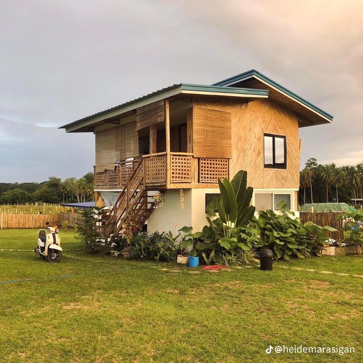 a small wooden house sitting on top of a lush green field