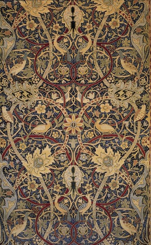 an intricately designed rug with birds and flowers on it's border, in blue tones