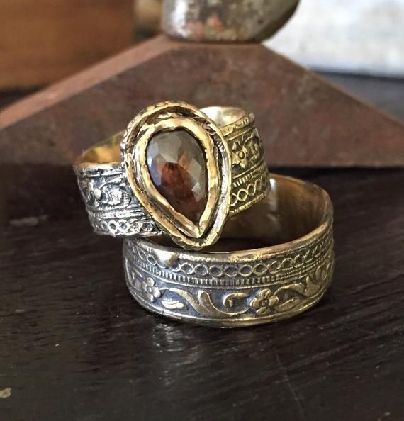 two rings sitting on top of a wooden table