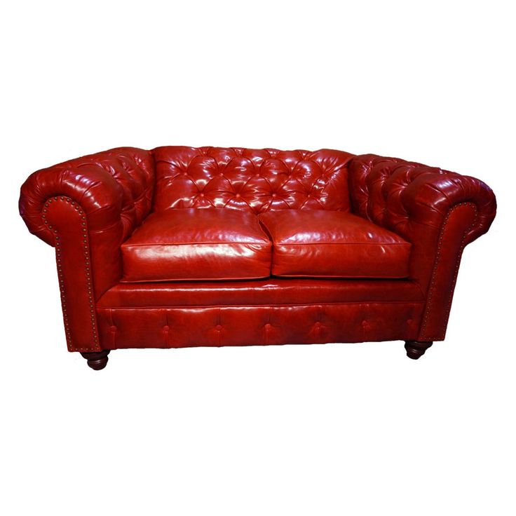 a red leather couch sitting on top of a white floor