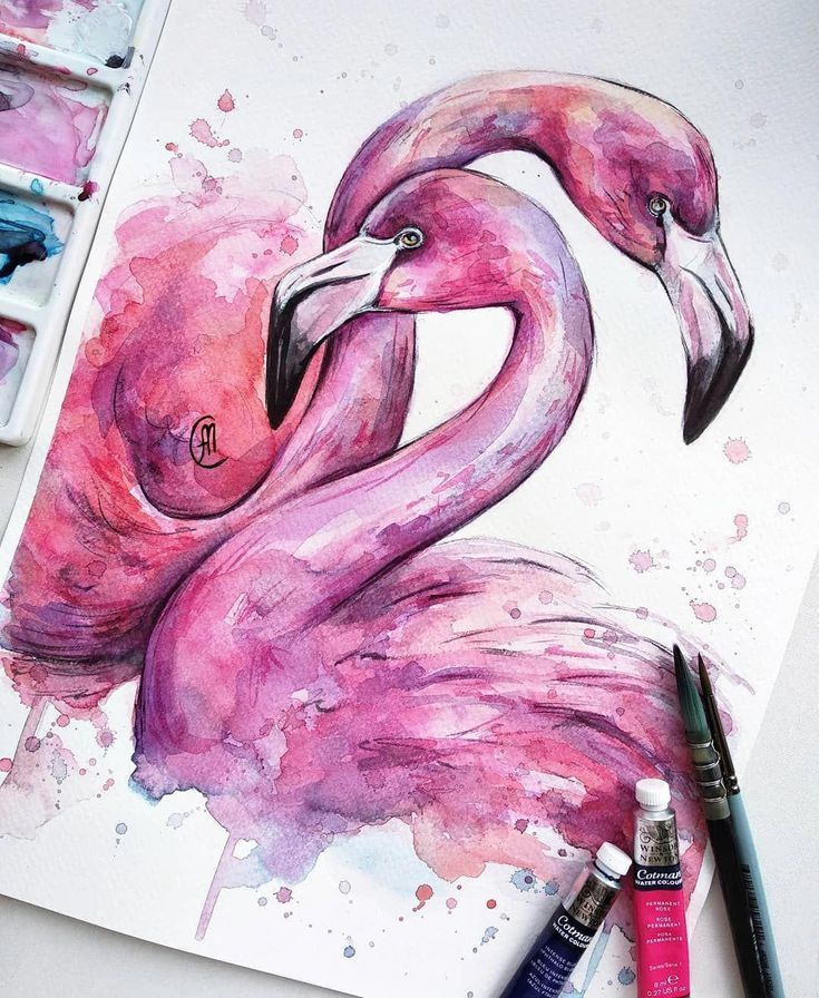 a painting of two pink flamingos with watercolors on the table next to it