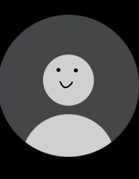 a black and white circle with a smiley face on it's center, in the dark