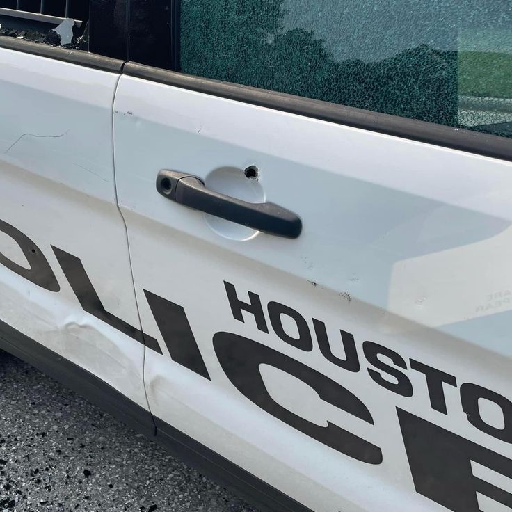 a police car with the word houston on it's side door is parked in a parking lot