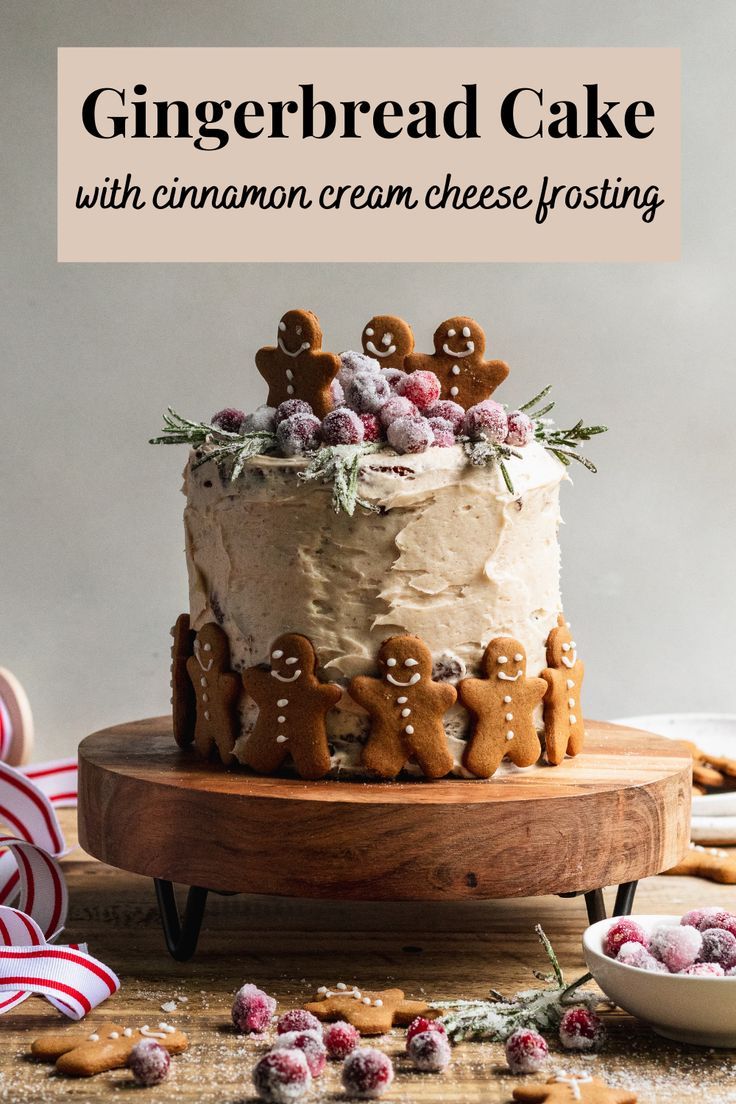 gingerbread cake with cinnamon cream cheese frosting on a wooden platter surrounded by cookies and candy