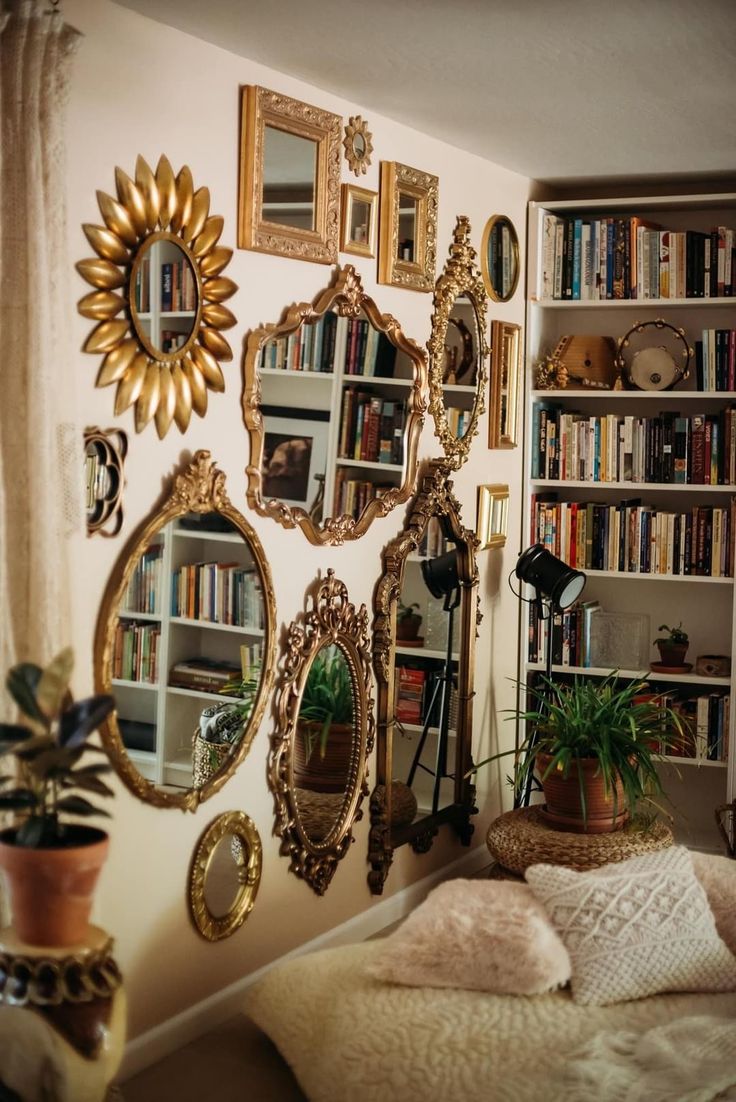 there are many mirrors hanging on the wall in this room with bookshelves and potted plants