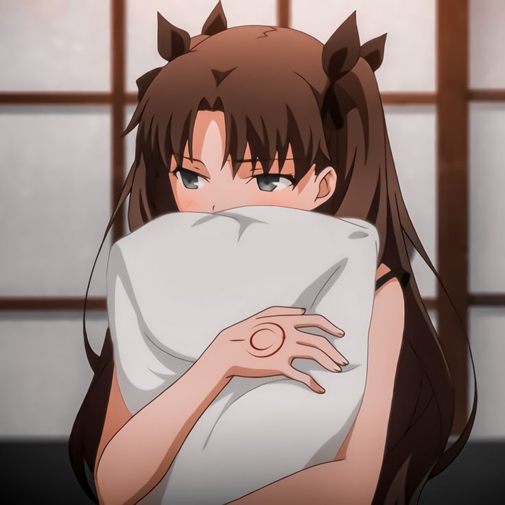 an anime character is covering her face with a pillow