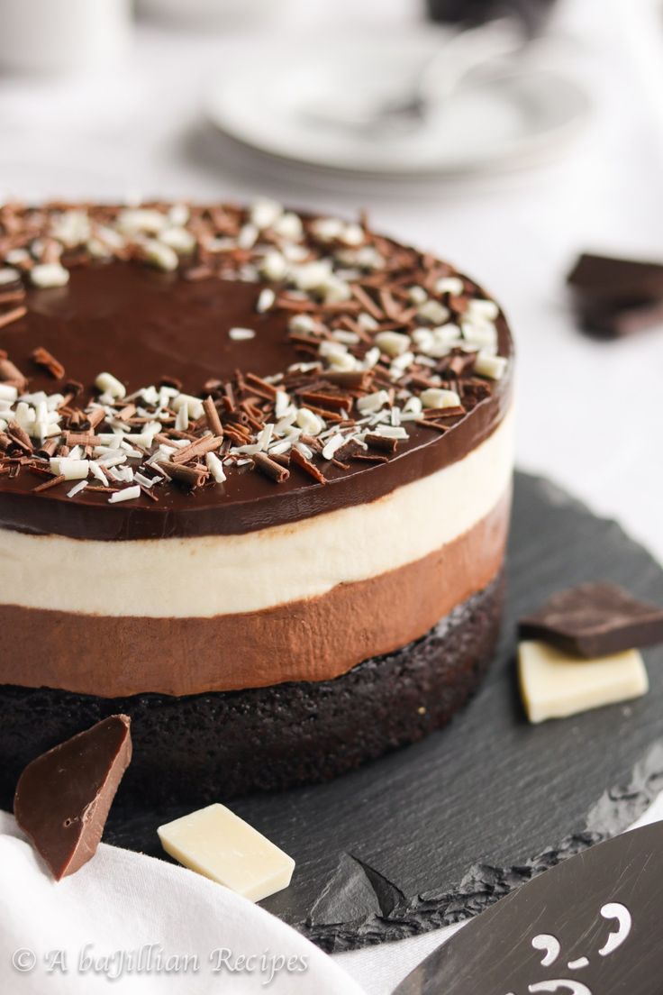 a chocolate cake with white and brown frosting