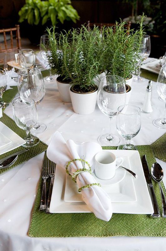 the table is set with dishes and place settings