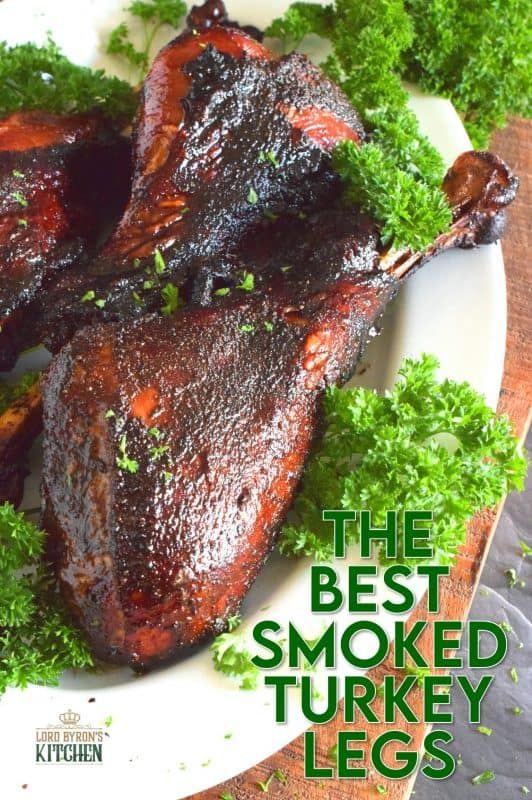 the best smoked turkey legs on a white plate with parsley garnishes