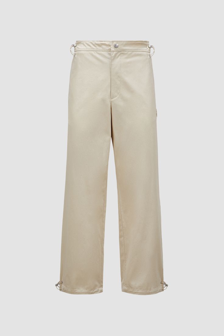 Crafted from soft cotton canvas, these slacks are fit a range of occasions. Drawstring fastening on the waist and cuffs enhance comfort. Chino Cotton Twill Pants For Work, Chino Cotton Twill Straight Pants For Work, Beige Wide Leg Cotton Pants With Straight Hem, Chino Cotton Twill Straight Work Pants, Beige Cotton Wide Leg Pants With Straight Hem, Beige Wide-leg Workwear Parachute Pants, Beige Wide-leg Parachute Pants For Work, Beige Straight Leg Parachute Pants For Workwear, Chino Cotton Twill Straight Pants With Belt Loops