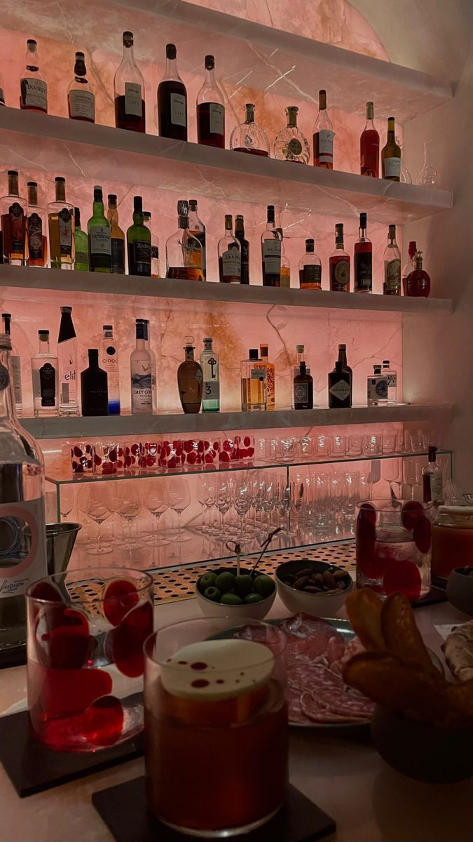 the bar is stocked with many different types of drinks and condiments on it