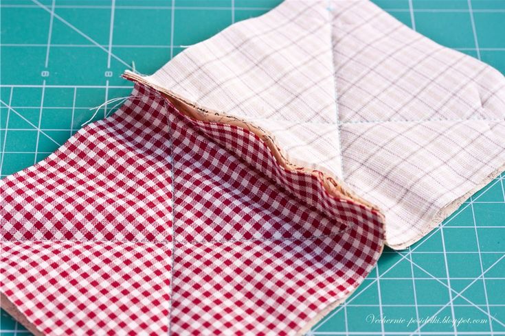 two pieces of fabric sitting on top of a cutting board