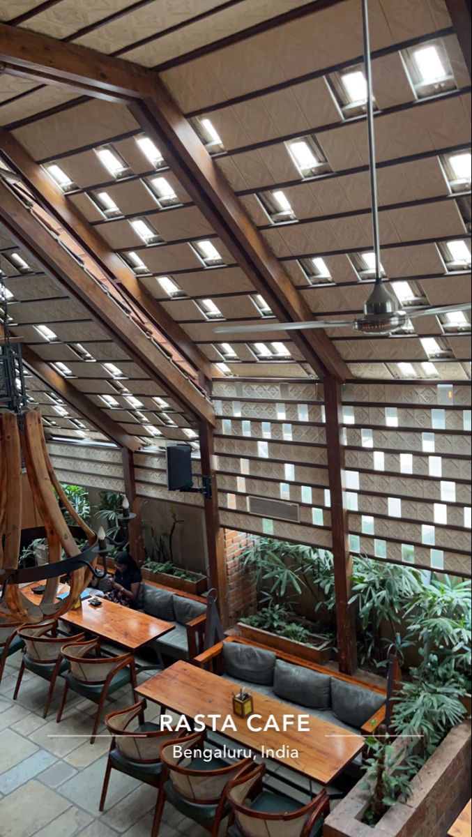 the inside of a restaurant with wooden tables and chairs